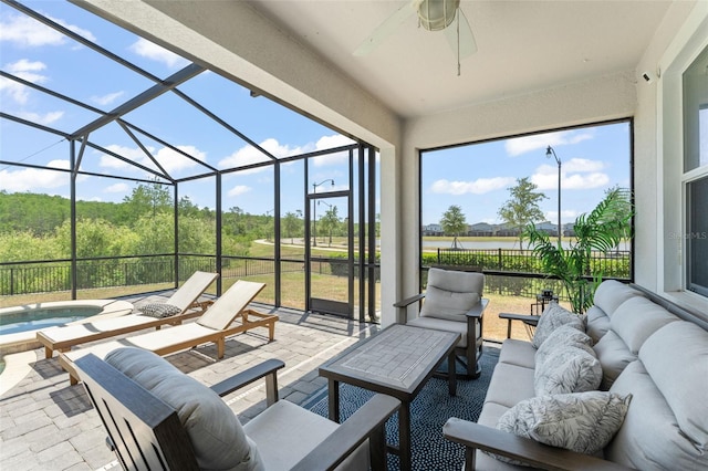 view of patio / terrace featuring glass enclosure, an in ground hot tub, an outdoor hangout area, and ceiling fan
