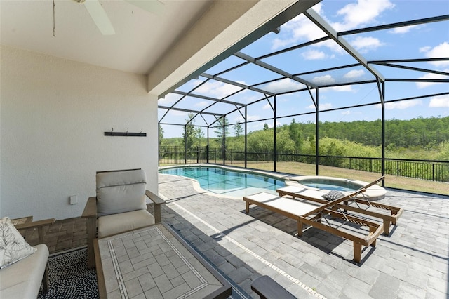view of pool with a patio, ceiling fan, a lanai, and a pool with connected hot tub