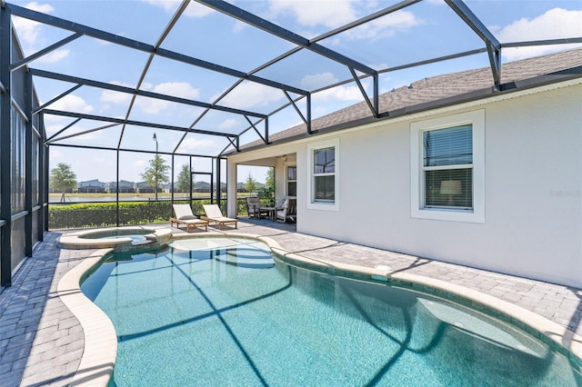 view of swimming pool with glass enclosure, a pool with connected hot tub, and a patio area