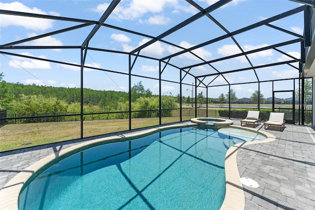 view of swimming pool with a yard, a patio, a pool with connected hot tub, and a lanai