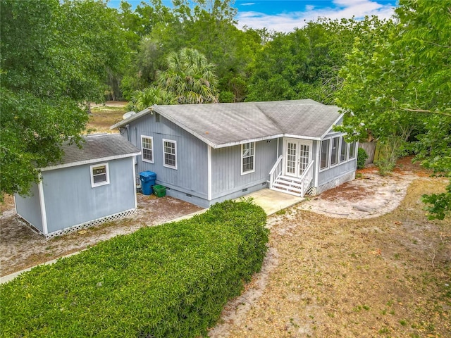 499 W Beresford Rd, Deland, FL 32720 - rear view of property featuring crawl space, roof with shingles, a sunroom, and an outbuilding