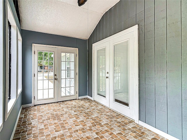 499 W Beresford Rd, Deland, FL 32720 - doorway to outside featuring french doors, baseboards, wood walls, and vaulted ceiling
