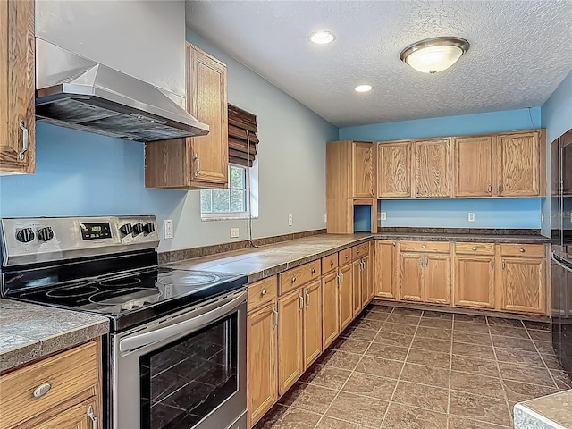 499 W Beresford Rd, Deland, FL 32720 - kitchen featuring stainless steel electric stove, under cabinet range hood, a textured ceiling, tile counters, and recessed lighting