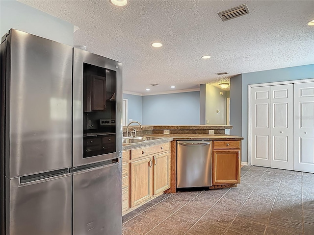 499 W Beresford Rd, Deland, FL 32720 - kitchen featuring stainless steel appliances, a sink, a textured ceiling, a peninsula, and recessed lighting