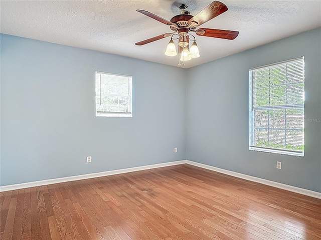 499 W Beresford Rd, Deland, FL 32720 - unfurnished room with hardwood / wood-style flooring, baseboards, ceiling fan, and a textured ceiling