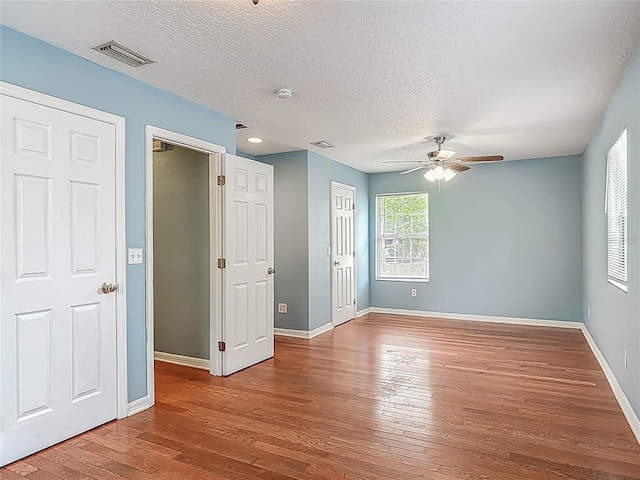 499 W Beresford Rd, Deland, FL 32720 - unfurnished room with ceiling fan, wood-type flooring, baseboards, and a textured ceiling