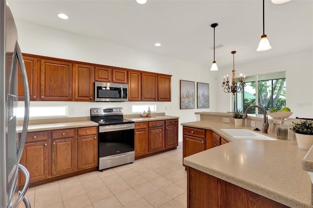 kitchen with a sink, light countertops, stainless steel appliances, and visible vents