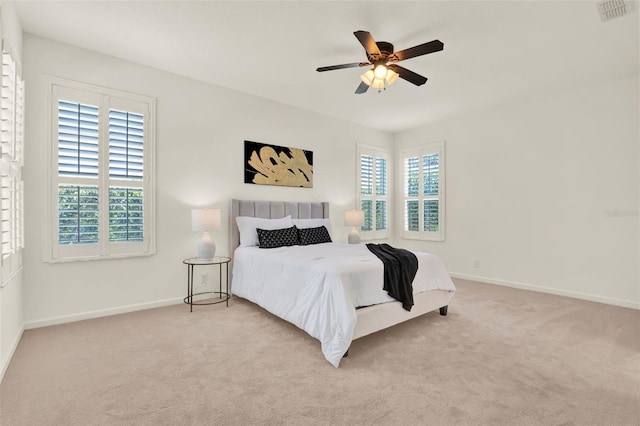 carpeted bedroom with baseboards, multiple windows, and visible vents