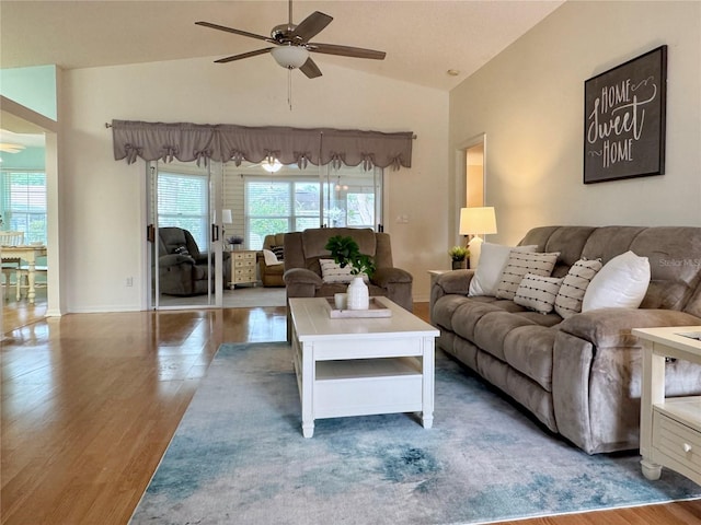 32900 Crooked Oaks Ln, Leesburg, FL 34748 - living area with ceiling fan, wood finished floors, vaulted ceiling, and baseboards