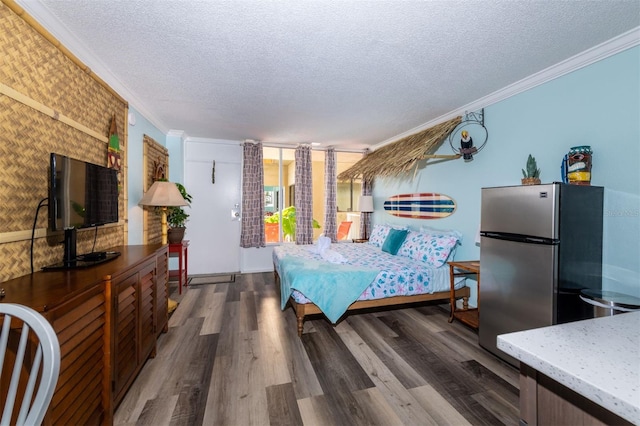 2043 S Atlantic Ave Unit 105, Daytona Beach Shores, FL 32118 - bedroom featuring freestanding refrigerator, a textured ceiling, and crown molding