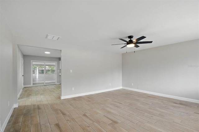 unfurnished room with a ceiling fan, baseboards, visible vents, and light wood-type flooring