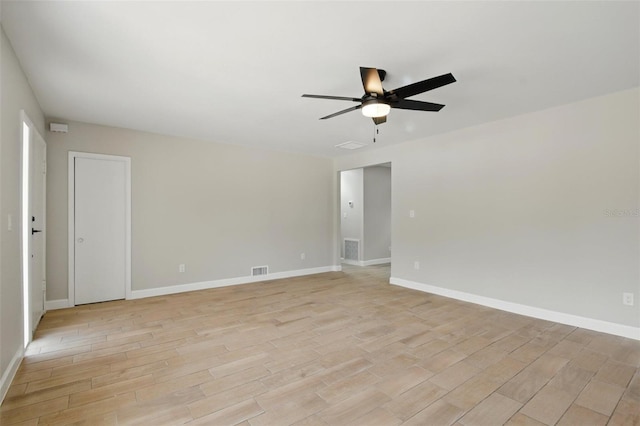 unfurnished room featuring ceiling fan, baseboards, and light wood finished floors