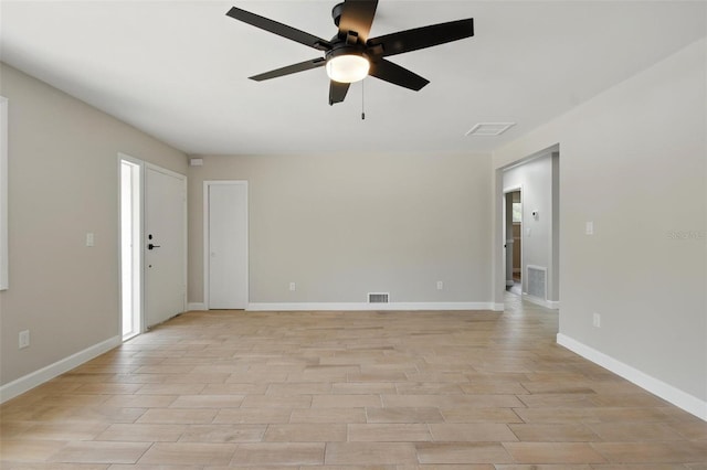 unfurnished room featuring light wood-style floors, ceiling fan, and visible vents