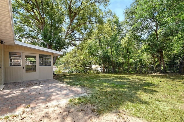 view of yard with fence and a patio