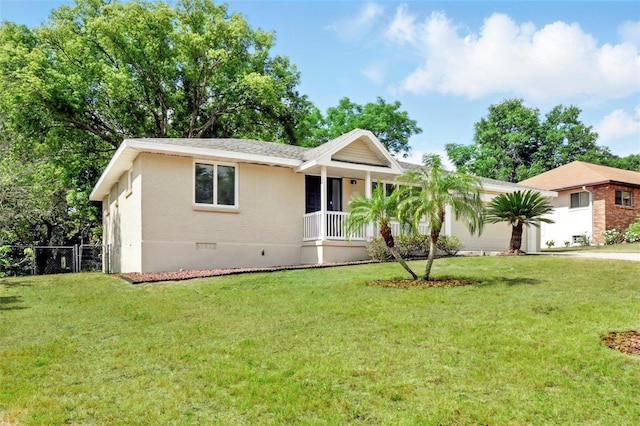 ranch-style home featuring crawl space, brick siding, fence, and a front yard