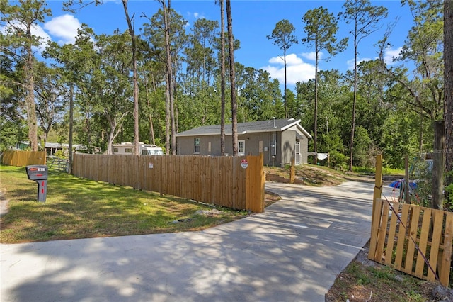 view of property exterior featuring fence private yard and driveway
