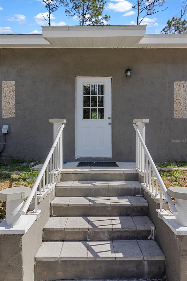 doorway to property with stucco siding