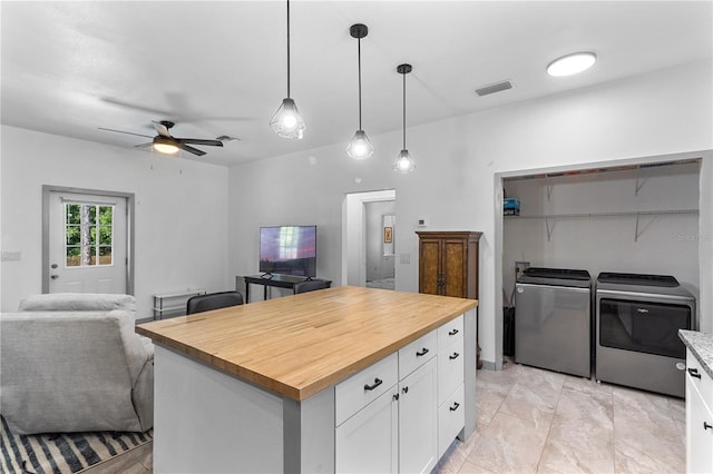 kitchen featuring white cabinets, ceiling fan, separate washer and dryer, butcher block countertops, and open floor plan