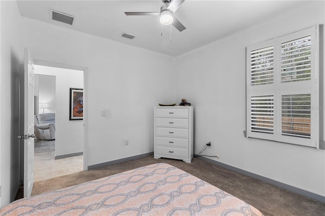 carpeted bedroom with baseboards, ceiling fan, and visible vents