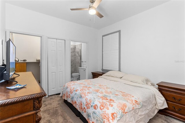 carpeted bedroom featuring ceiling fan, a closet, and ensuite bath