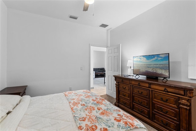 carpeted bedroom featuring a ceiling fan and visible vents