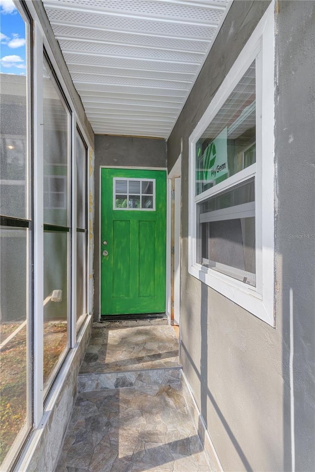 doorway to property with stucco siding