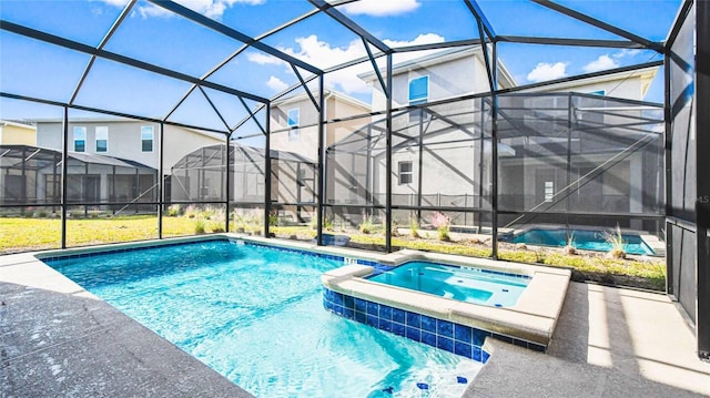 2936 Protagonist St, Kissimmee, FL 34746 - view of swimming pool featuring glass enclosure, a pool with connected hot tub, and a patio area