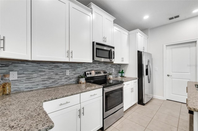 kitchen featuring appliances with stainless steel finishes, tasteful backsplash, visible vents, and white cabinets