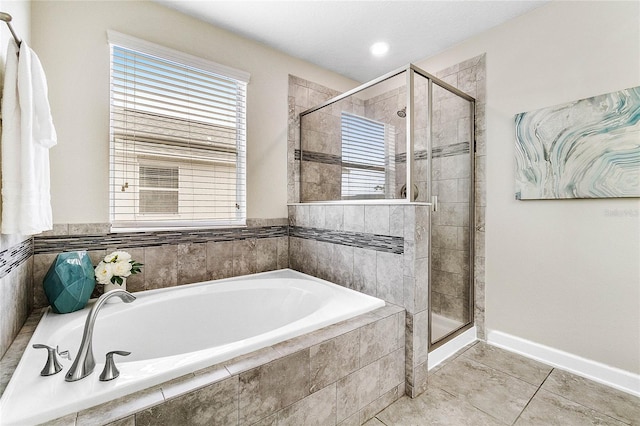 full bath with baseboards, tile patterned flooring, a garden tub, and a stall shower