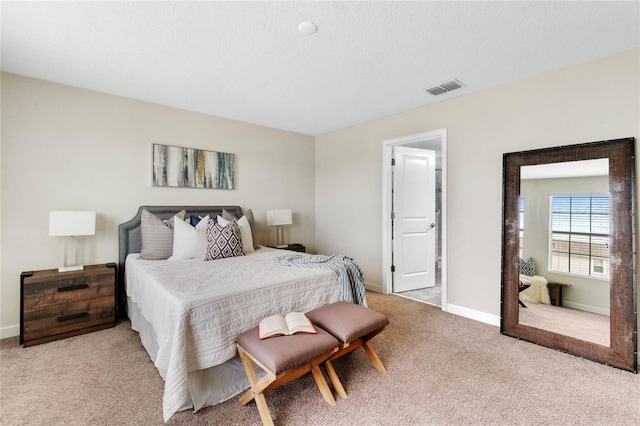 bedroom featuring visible vents, baseboards, and light carpet