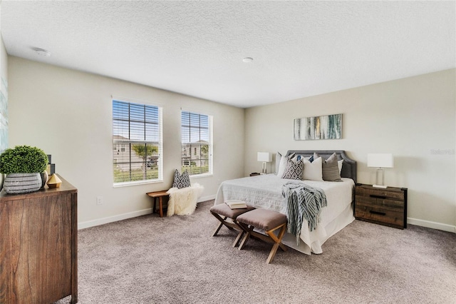 carpeted bedroom featuring a textured ceiling and baseboards