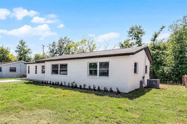 2105 9th St NE, Winter Haven, FL 33880 - view of side of home featuring central AC, stucco siding, and roof with shingles