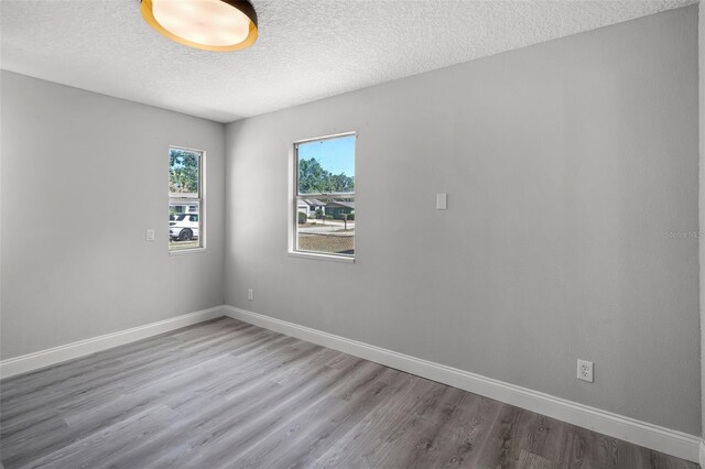 2105 9th St NE, Winter Haven, FL 33880 - unfurnished room featuring a textured ceiling, wood finished floors, and baseboards