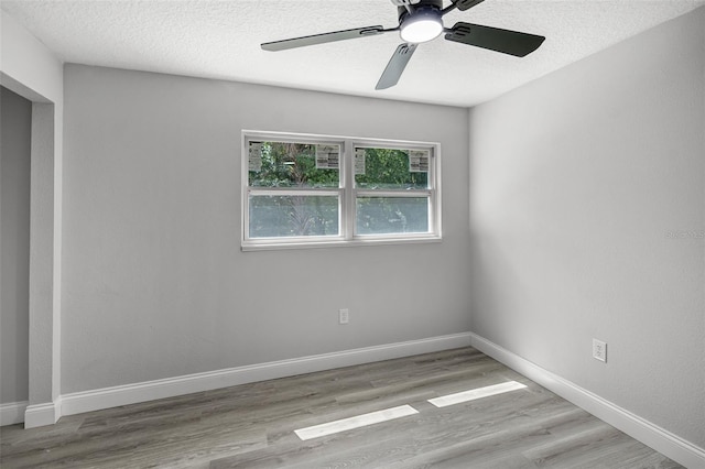 2105 9th St NE, Winter Haven, FL 33880 - unfurnished room with a textured ceiling, wood finished floors, baseboards, and ceiling fan