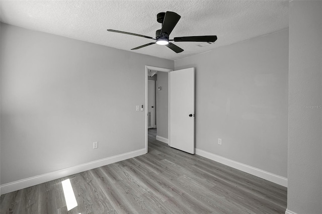 2105 9th St NE, Winter Haven, FL 33880 - interior space featuring baseboards, ceiling fan, a textured ceiling, and wood finished floors