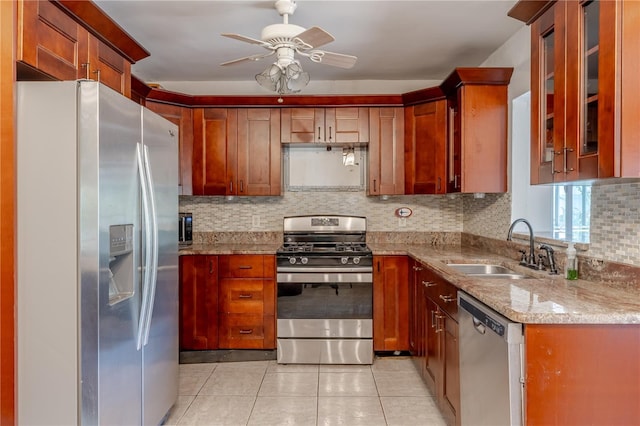1108 Gibson St, Leesburg, FL 34748 - kitchen with appliances with stainless steel finishes, a sink, decorative backsplash, light tile patterned floors, and ceiling fan