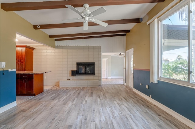 1108 Gibson St, Leesburg, FL 34748 - unfurnished living room featuring a ceiling fan, wood finished floors, a brick fireplace, and baseboards