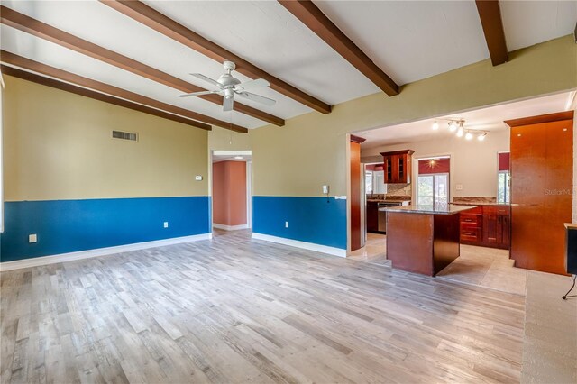 1108 Gibson St, Leesburg, FL 34748 - unfurnished living room featuring light wood-style floors, ceiling fan, and baseboards