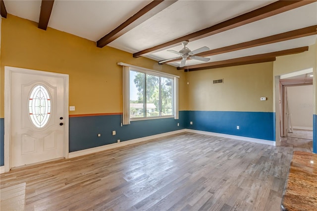 1108 Gibson St, Leesburg, FL 34748 - foyer entrance with beamed ceiling, wood finished floors, ceiling fan, and baseboards