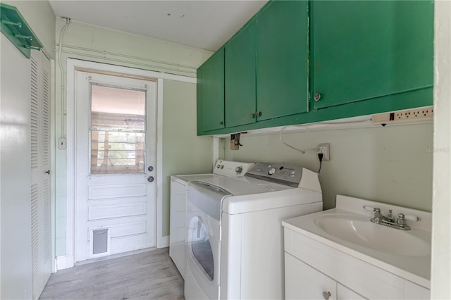 1108 Gibson St, Leesburg, FL 34748 - washroom featuring cabinet space, washer and dryer, and light wood finished floors