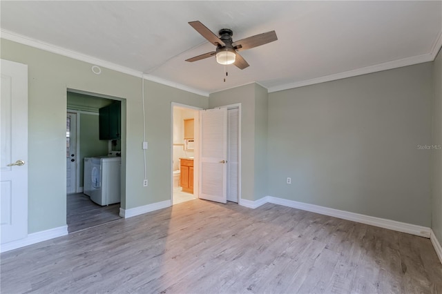 1108 Gibson St, Leesburg, FL 34748 - unfurnished bedroom featuring washing machine and dryer, ornamental molding, wood finished floors, and baseboards