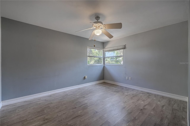 1108 Gibson St, Leesburg, FL 34748 - unfurnished room featuring wood finished floors, a ceiling fan, and baseboards