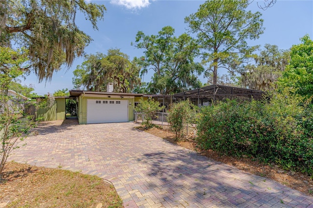 1108 Gibson St, Leesburg, FL 34748 - view of front of property with a garage, fence, and decorative driveway
