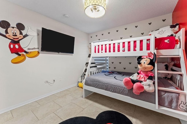 bedroom featuring a textured ceiling and baseboards