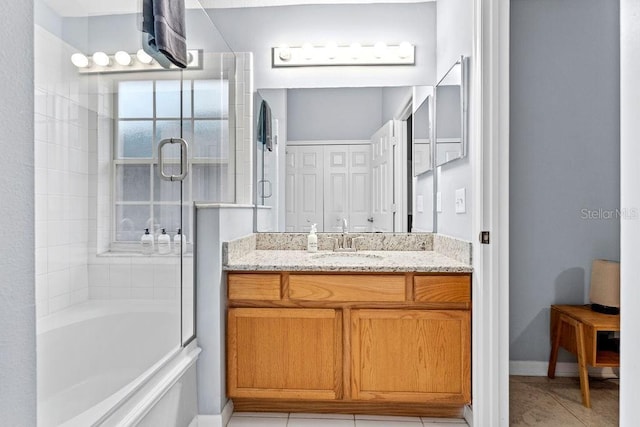 full bathroom featuring tile patterned flooring and vanity