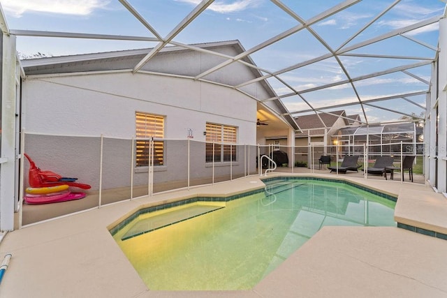 view of pool featuring a fenced in pool, glass enclosure, a patio area, and ceiling fan