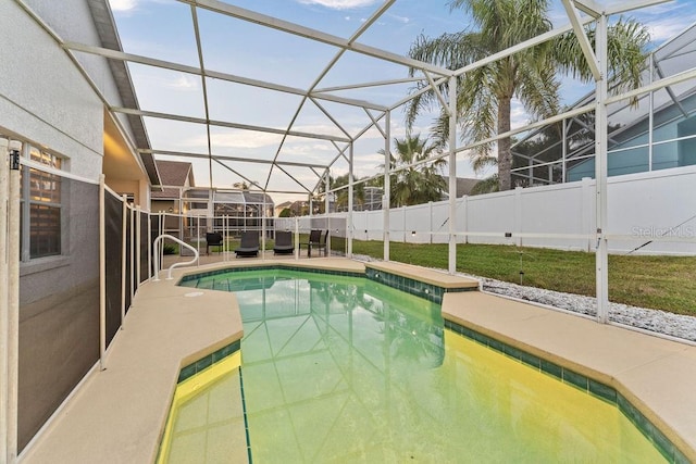 view of pool featuring a patio, glass enclosure, fence, and a fenced in pool
