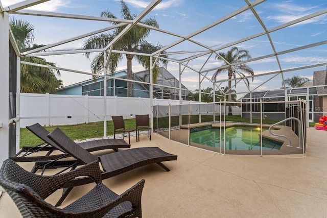 view of swimming pool with a fenced in pool, a lanai, a fenced backyard, and a patio area