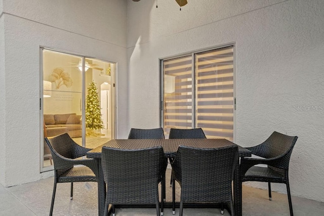 dining room with a ceiling fan and a textured wall