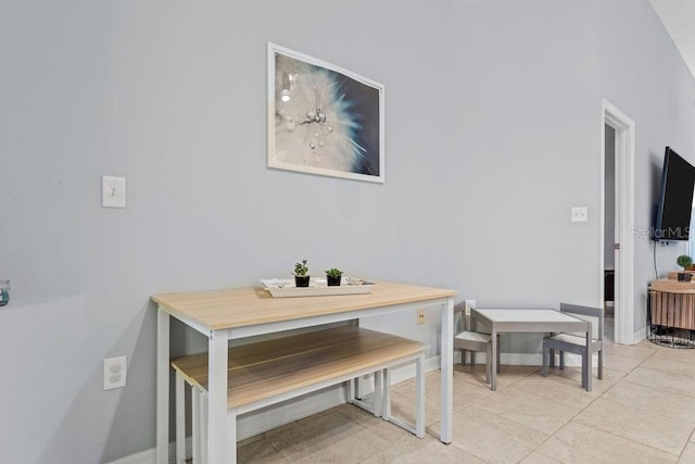 dining area featuring baseboards and light tile patterned flooring